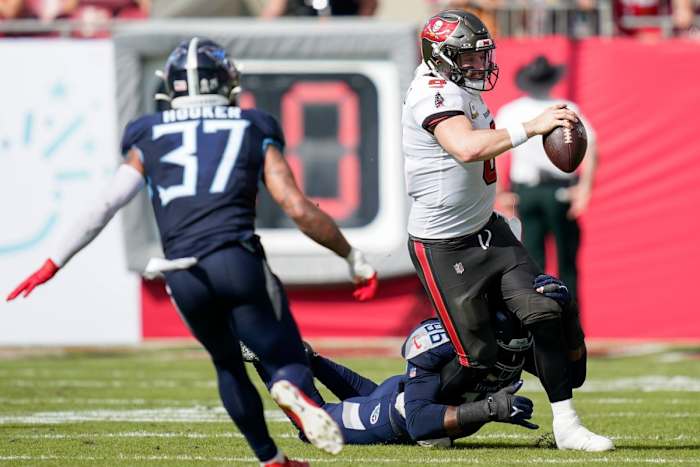 Tampa Bay Buccaneers quarterback Baker Mayfield (6) is brought down by Tennessee Titans defensive end Denico Autry (96) on a keeper.